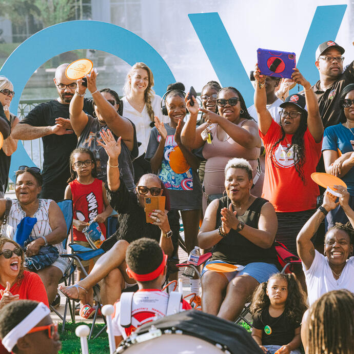 A crowd cheering for the Katherine Johnson Elementary School Crimson Thunder Drumline