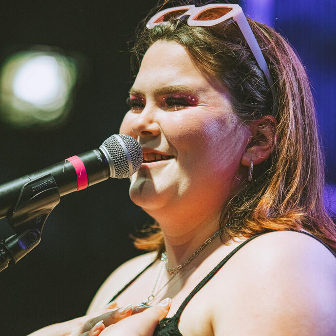 A female singer smiling