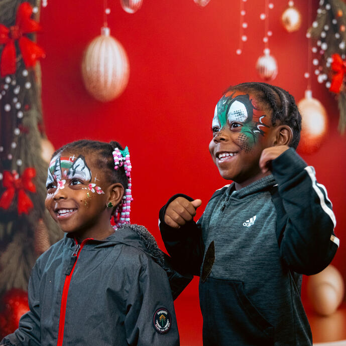 Two excited children with their faces painted