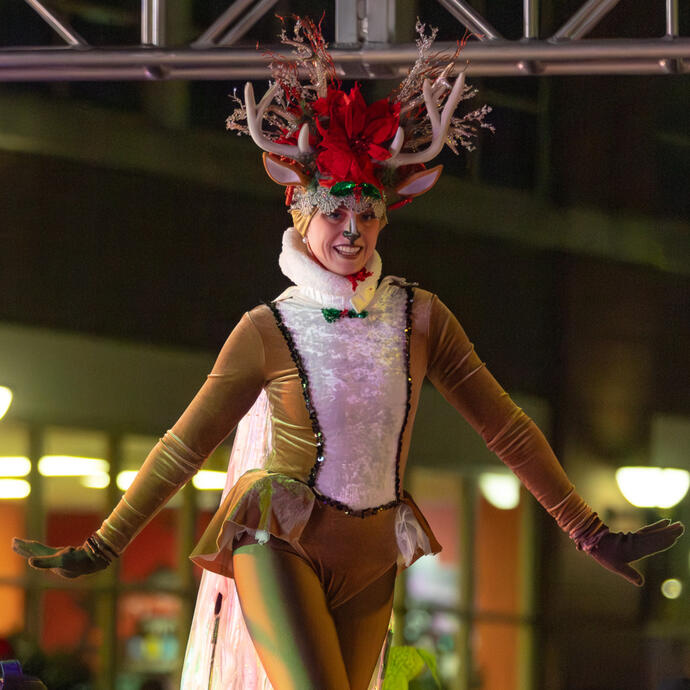 Woman on stilts dressed as a reindeer