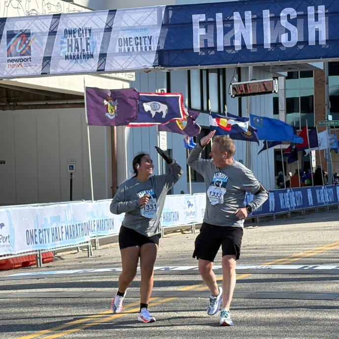 One City Marathon runners high-five at the finish line