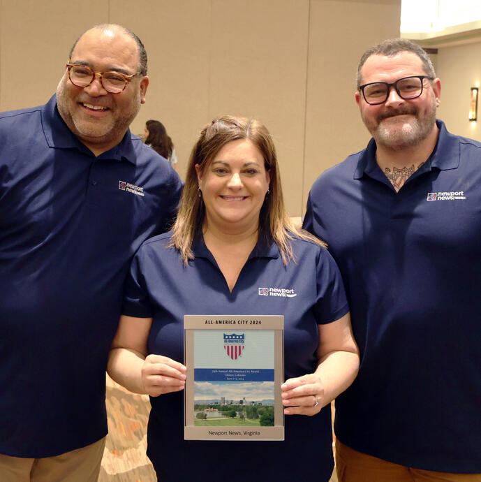 Three members of Team Newport News holding All-America City award
