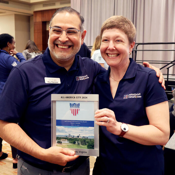 Two members of Team Newport News holding All-America City award