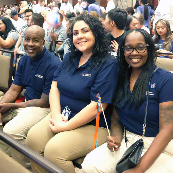 Three members of Team Newport News smiling