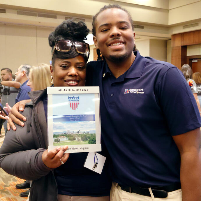 Two members of Team Newport News holding All-America City award